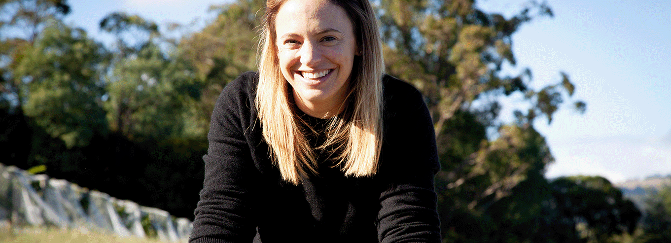 Woman smiling at Cloak & Dagger vineyard